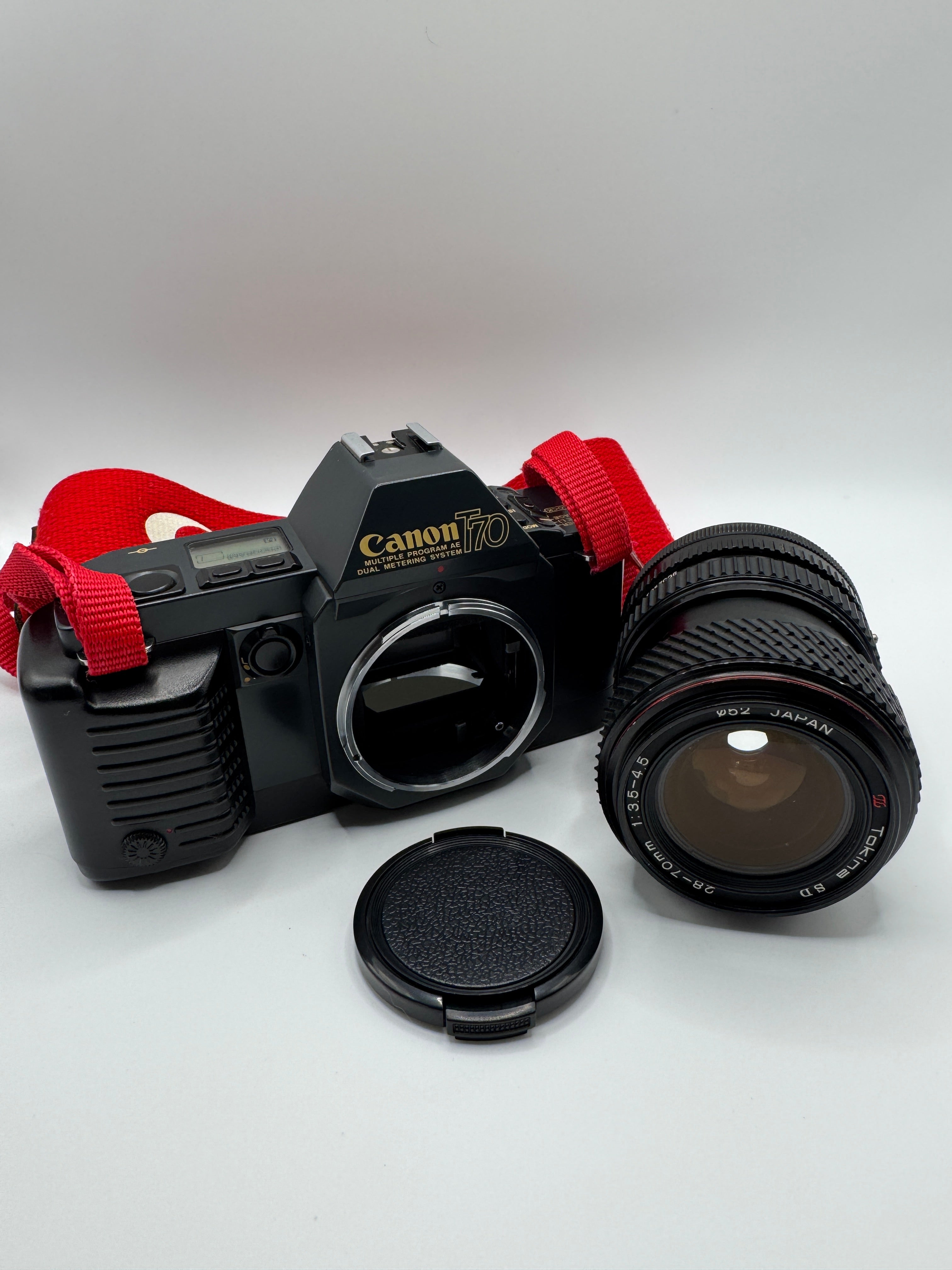 Canon T70 35mm Film Camera + Tokina 28–70mm Zoom Lens
Fully Tested | Excellent Condition | Ready to Shoot
