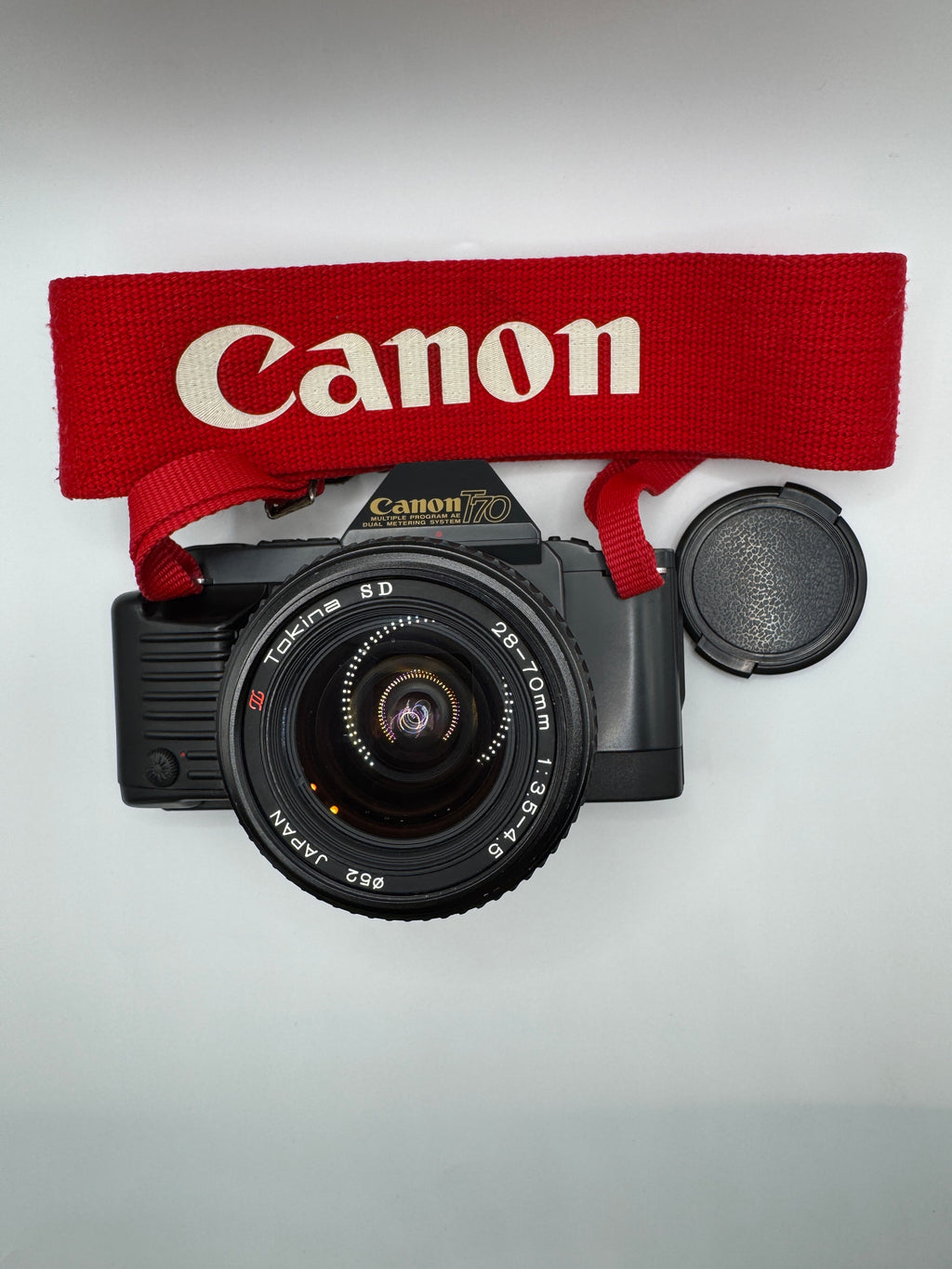 Canon T70 35mm Film Camera + Tokina 28–70mm Zoom Lens
Fully Tested | Excellent Condition | Ready to Shoot