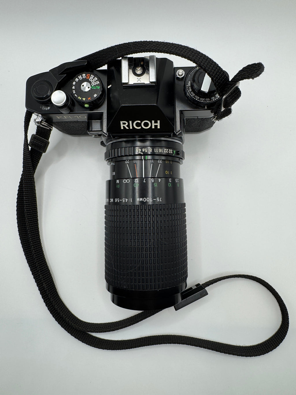 Ricoh KR-10 35mm Film Camera + Hanimex 75–200mm f/4.5–5.6 Zoom Lens (Boxed)
Fully Tested | Excellent Condition | Ready to Shoot